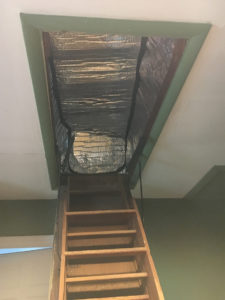 attic entry in the ceiling with insulated pad