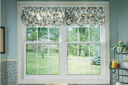 two double hung windows with curtains