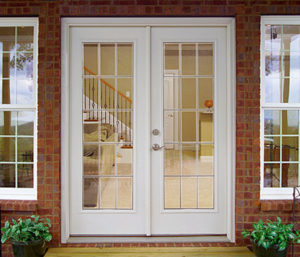 French door with grids on a brick home.