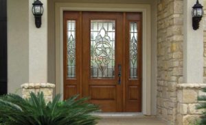 Woodgrain fiberglass front door with decorative glass and sidelites.