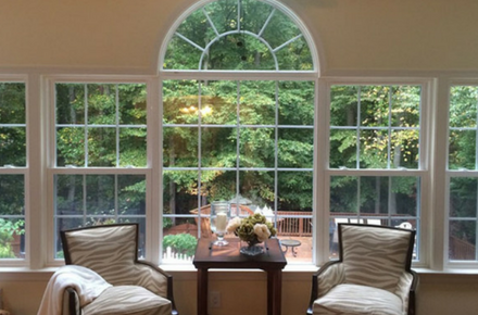 Energy-efficient picture windows with double-hung windows and one round-top window above.