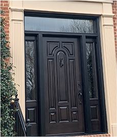 Black door with a white door frame for a brick house
