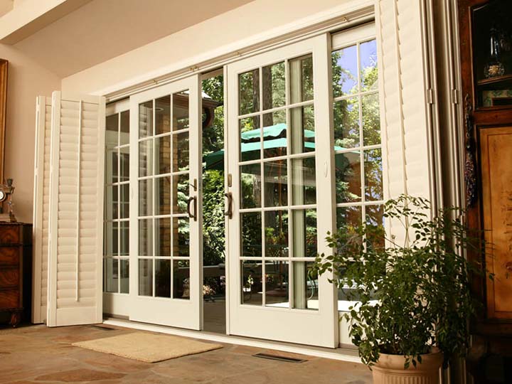 Sliding white glass patio door with grids, partially open.