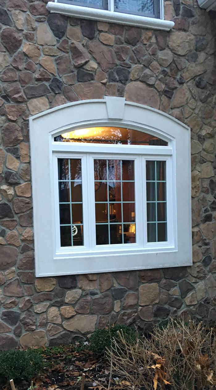 White framed paneled window with an arch