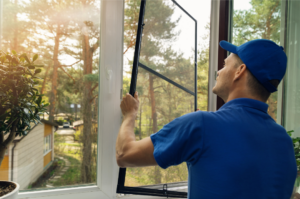 Professional window installer putting in new windows with a view of the outdoors